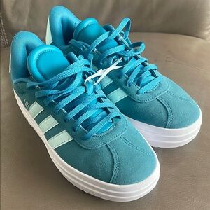 Adidas Teal Sneakers with lt blue Stripes.  Suede New without tag. It is unused